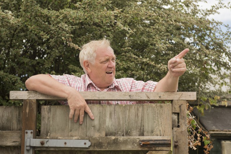 Man yelling over fence