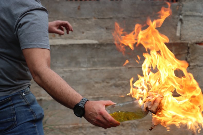 Man holding a Molotov cocktail
