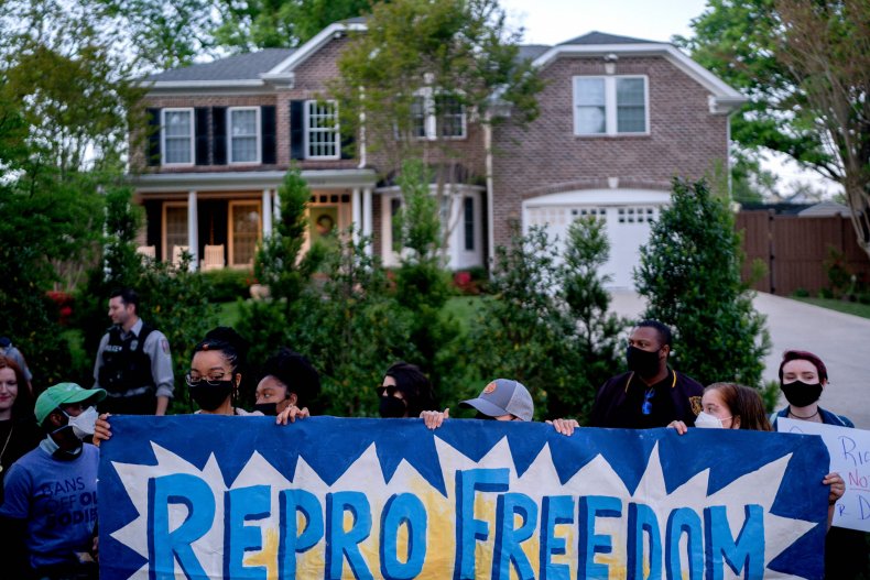 Pro-choice demonstrators gather outside the house of