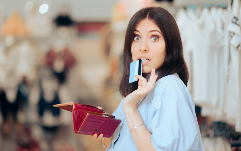 A woman holding her wallet and card.