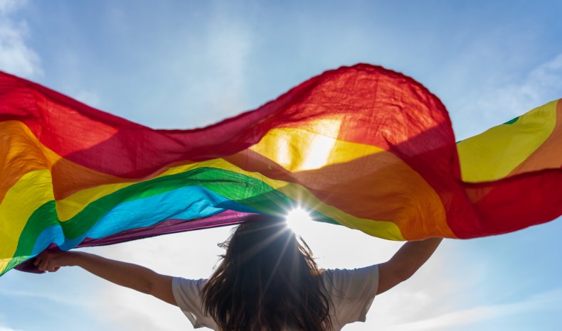 Picture of a young woman waving lgbti 