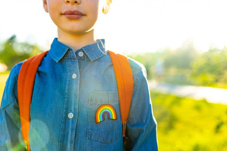 Girl in denim t-shirt with rainbow symbol 