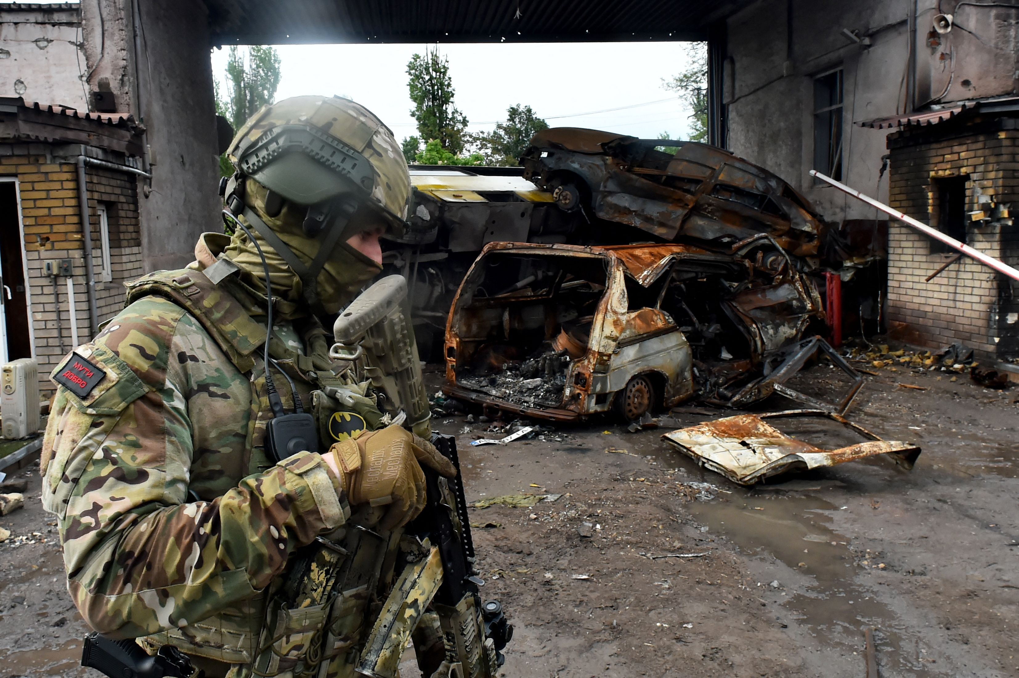 A shell-shocked Ukrainian soldier in a trench is getting taken