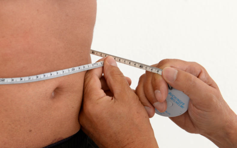 A man having his waist measured.