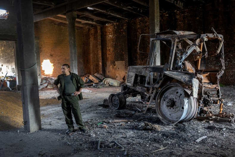 Ukraine farm workers in damaged grain storage