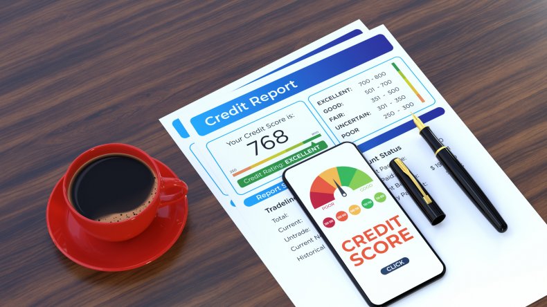 A credit report next to red cup.
