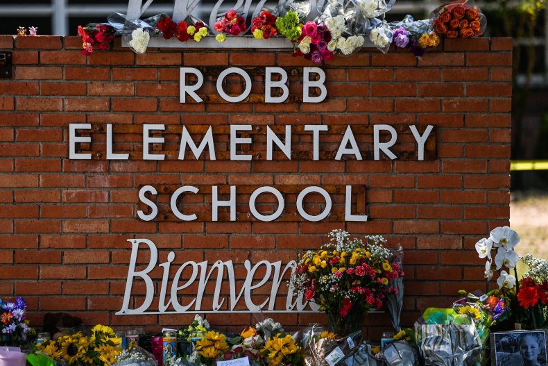 Flowers are placed on a makeshift memorial