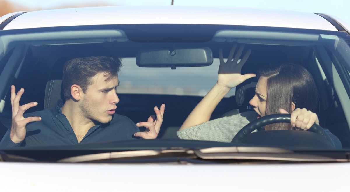 Couple arguing in car while driving