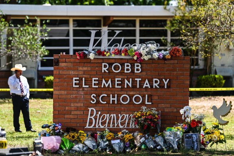 Flowers are placed on a makeshift memorial