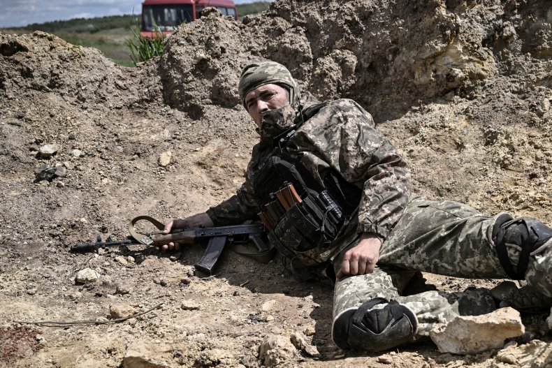 Ukraine soldier takes cover in Donbas shelling