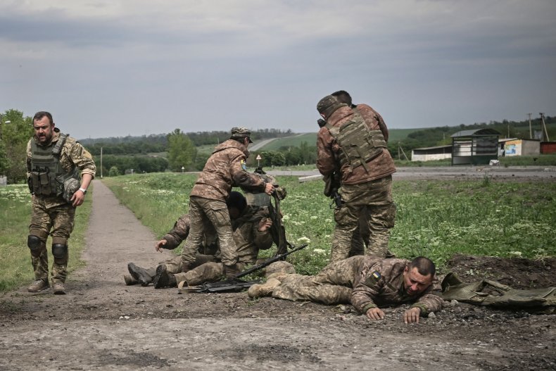 Ukraine soldiers help eachother near Donbas frontline