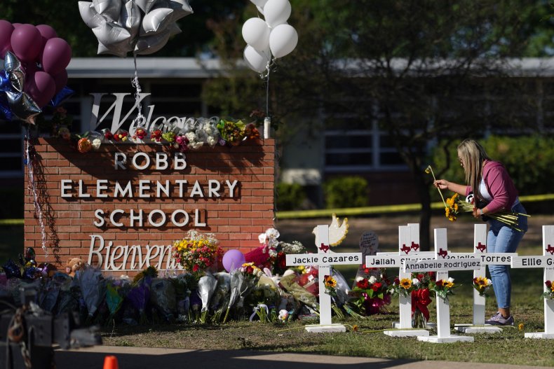 People drop off flowers at a makeshift