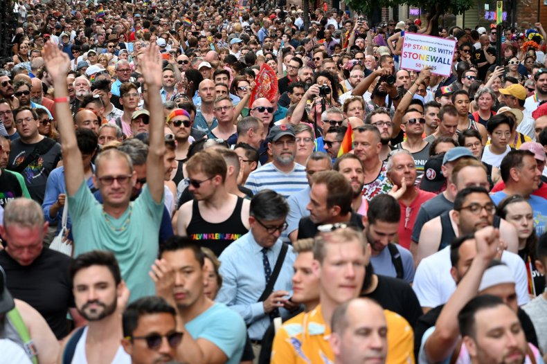 Crowds gather on Christopher Street outside the