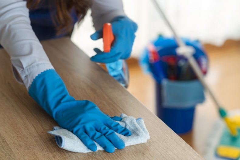 Cleaner wipes down side with cloth