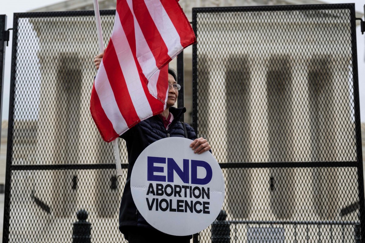 A pro-life demonstrator stands in front of
