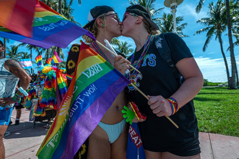 A couple kissing in a Pride parade