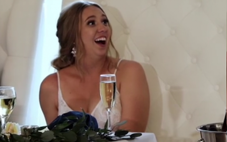 A bride being surprised at her wedding.