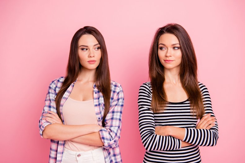 Two women with arms crossed.