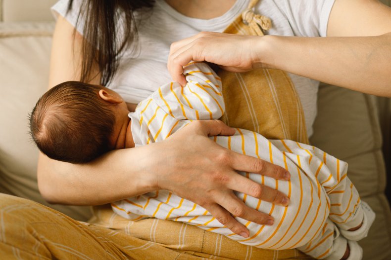 A woman breastfeeding a baby. 