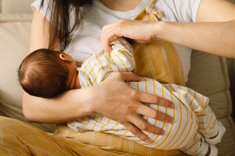 A woman breastfeeding a baby.