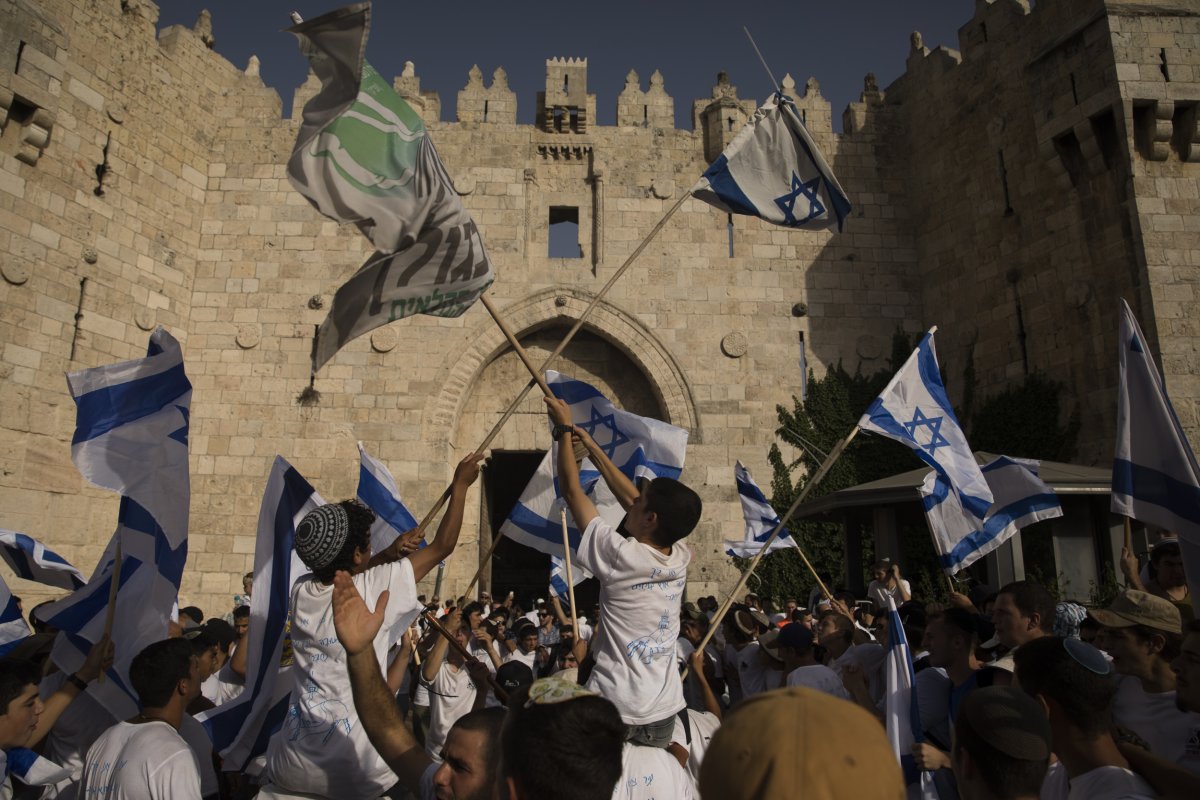 Israeli Jewish citizens dance and hold Israeli