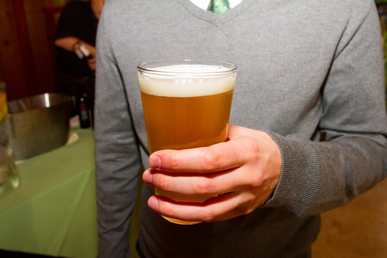 File photo of man holding beer.