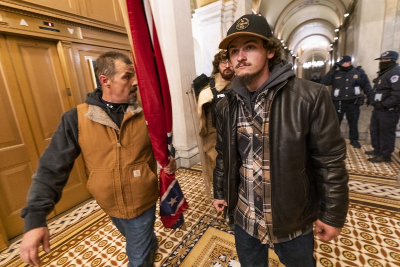 Kevin Seefried carrying a confederate battle flag