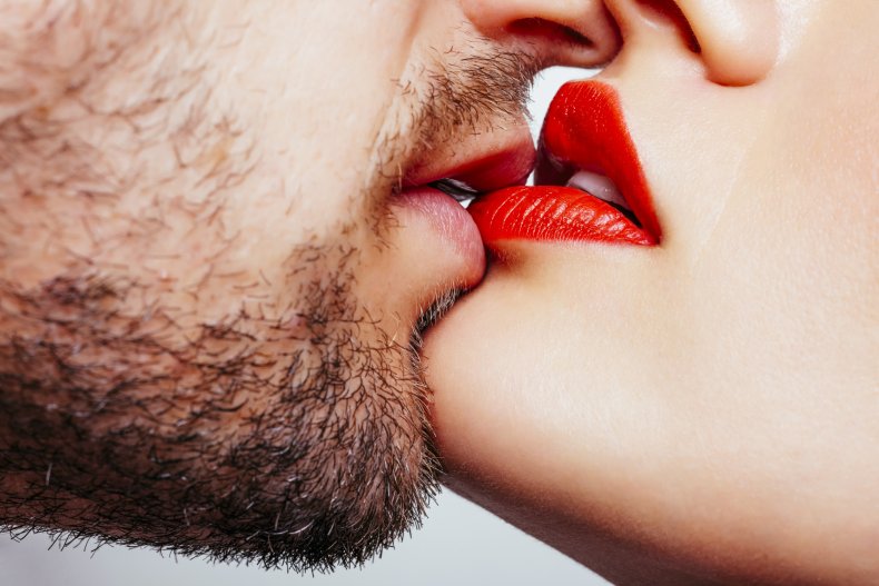 Woman kissing man with beard