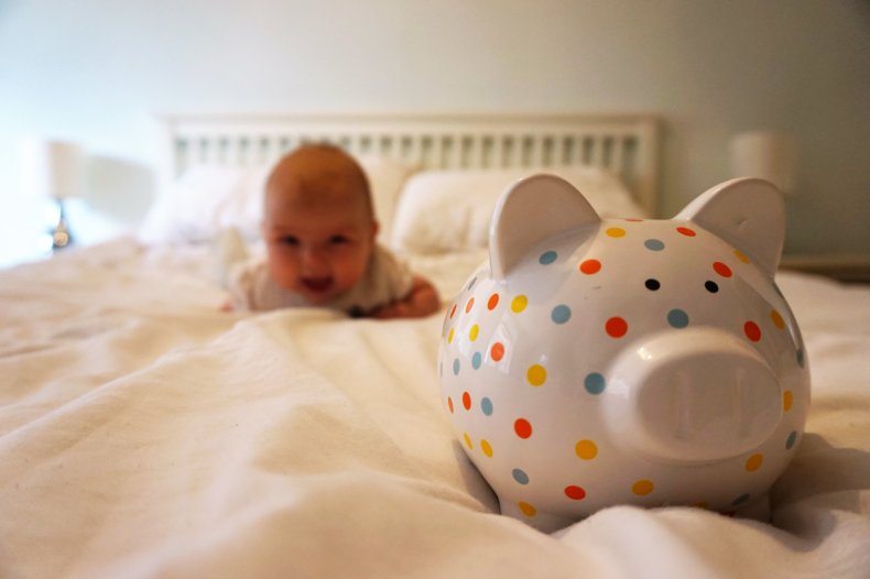 baby with piggy bank