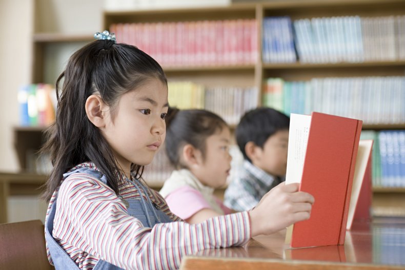 Little girl reading book
