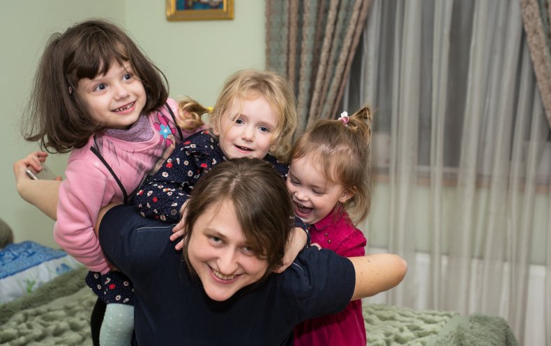 File photo of woman playing with kids.