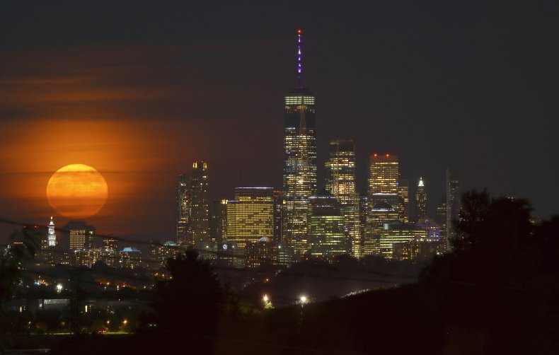 The Strawberry Moon behind Manhattan, New York