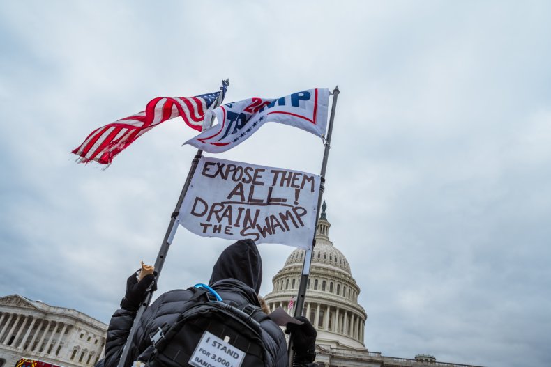 A man holding signs and flags