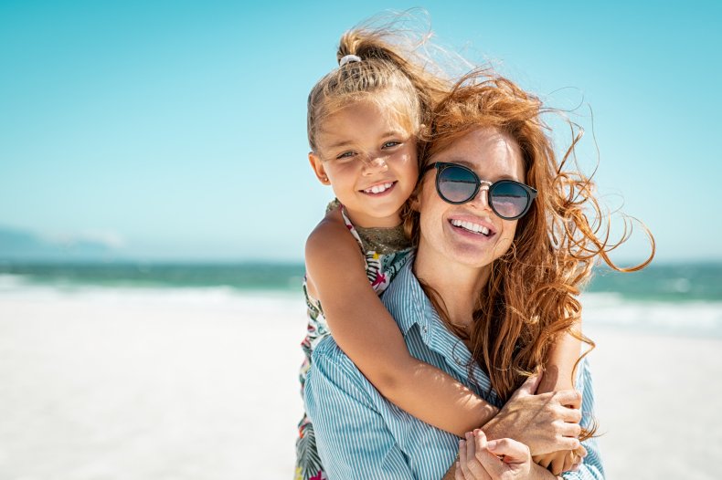 A daughter and young mom at beach.