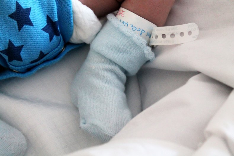 Newborn baby foot with name tag