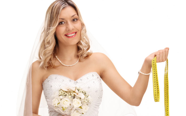 A wedding bride with a tape measure.