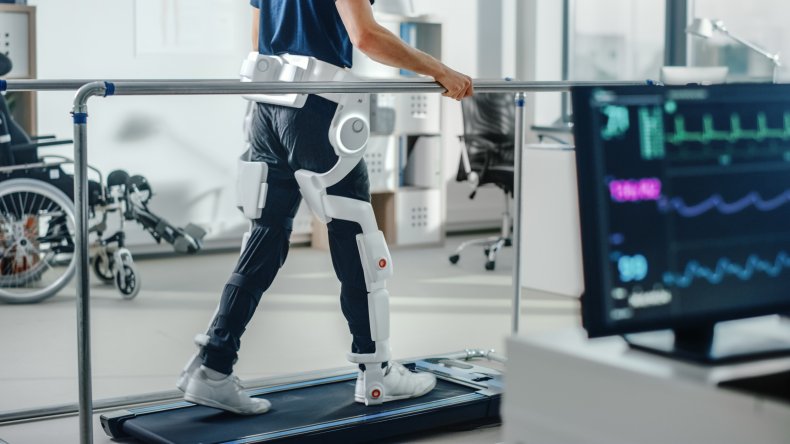 Man on a treadmill wearing robotic esoskeleton