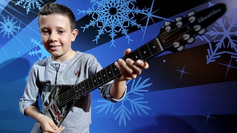 Boy plays Paper Jamz guitar