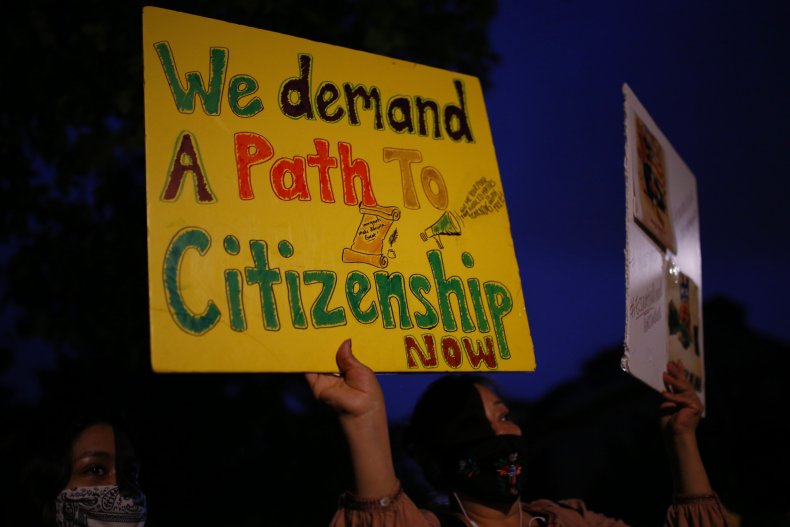 A woman holds up signs