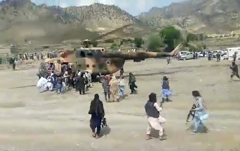 Taliban fighters secure a government helicopter 