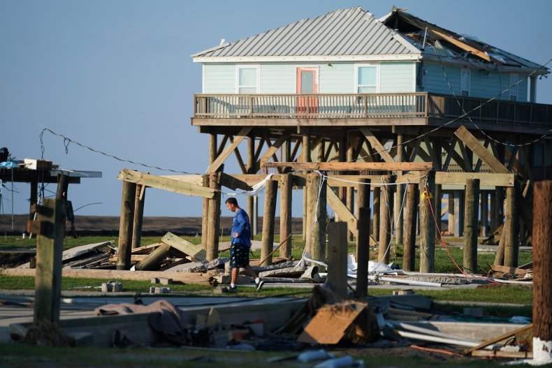 A man looks through storm debris