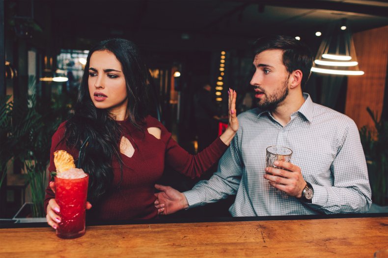 Man and woman argue at bar