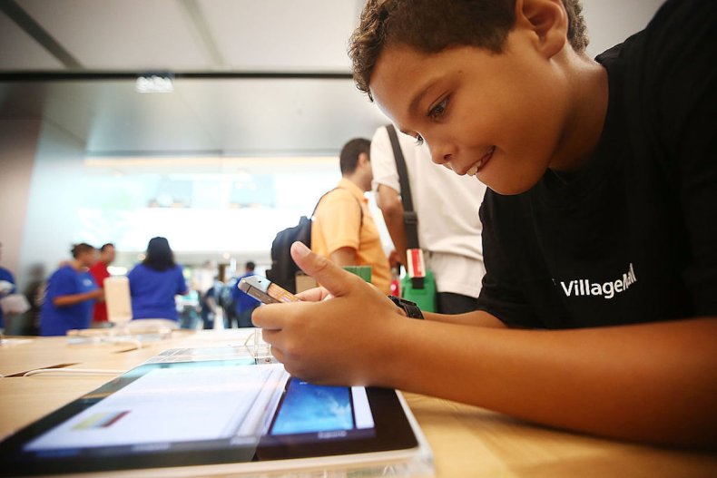 Boy using iPhone in Brazil Apple Store