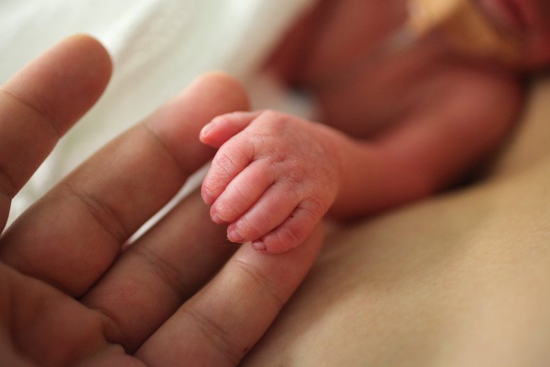 Premature baby's hand held