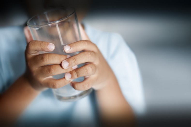 A child holding an empty glass