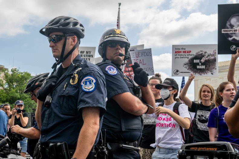 Demonstrators protest in front of SCOTUS