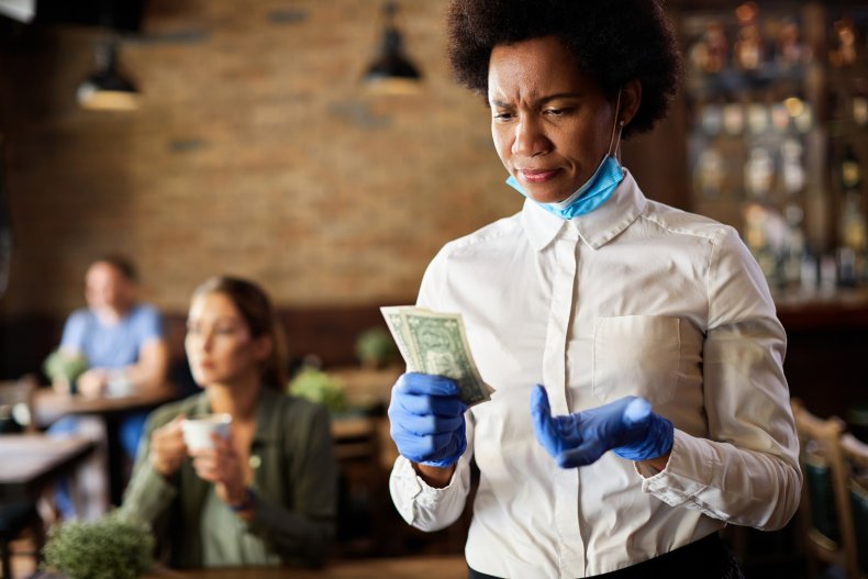 Waitress holding small tip