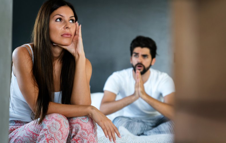 Couple arguing in bed