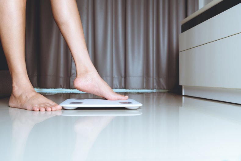 Person checking weight on scales