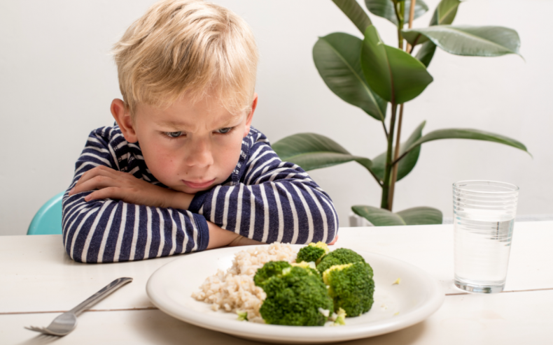 A boy staring at some food.